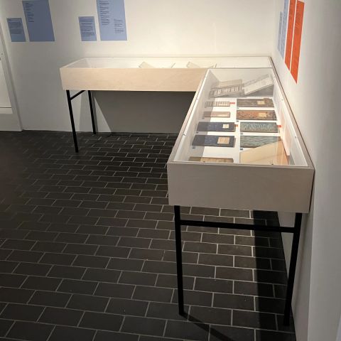 Console vitrine fixed to gallery wall.