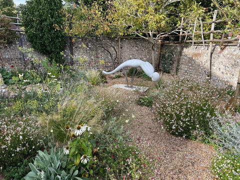 Outdoor sculptural work installed in a garden setting.