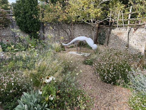 Outdoor sculptural work installed in a garden setting.